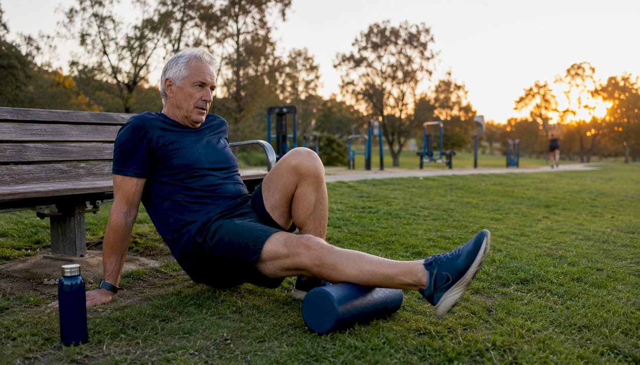 Mature athlete stretching muscles in gym