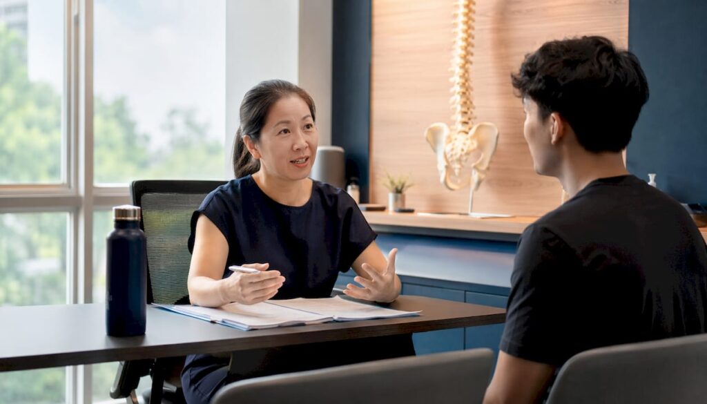Chiropractor discussing lifestyle counseling with patient