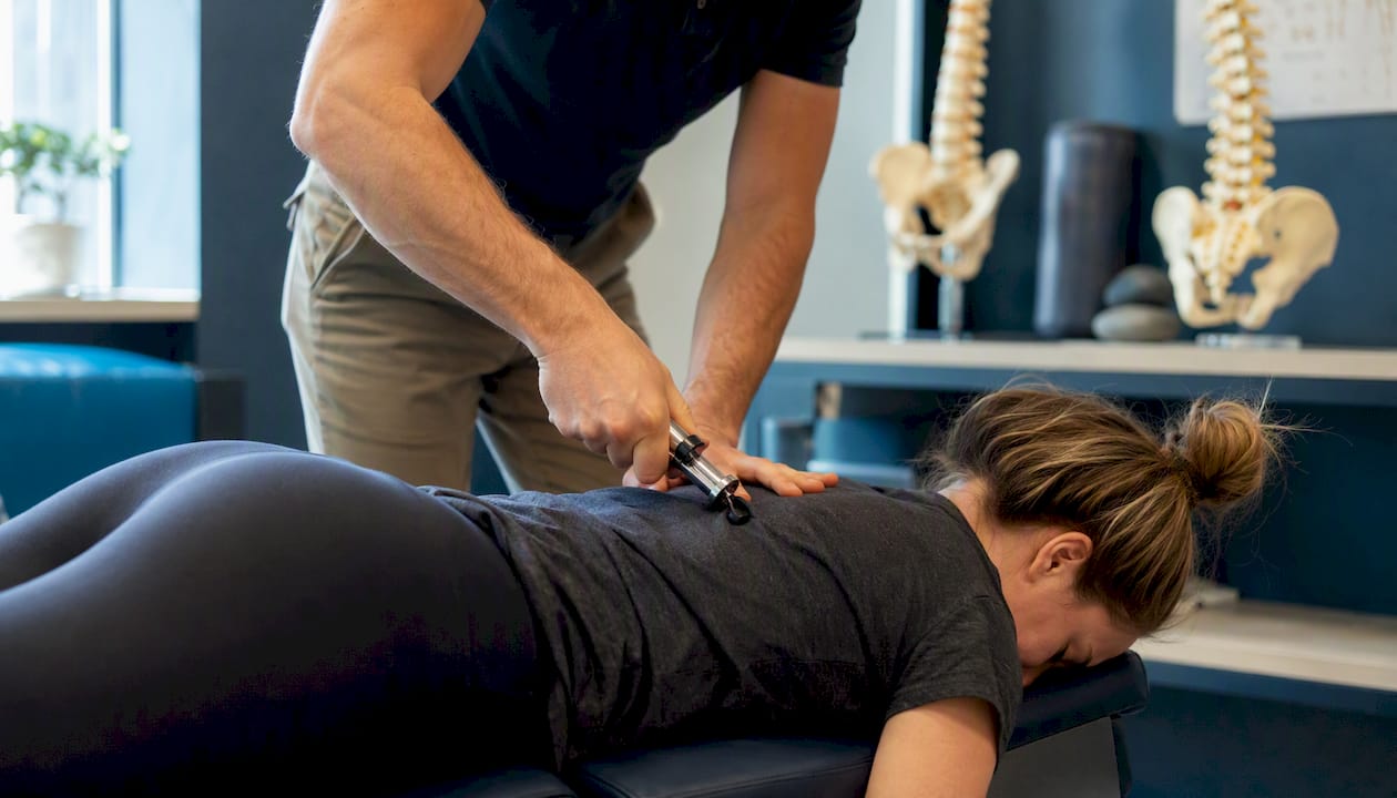 Chiropractor using gentle adjustment instrument