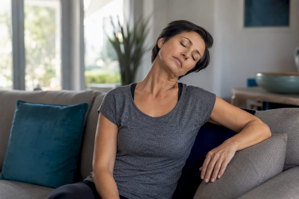 Person doing neck tilt stretch in office