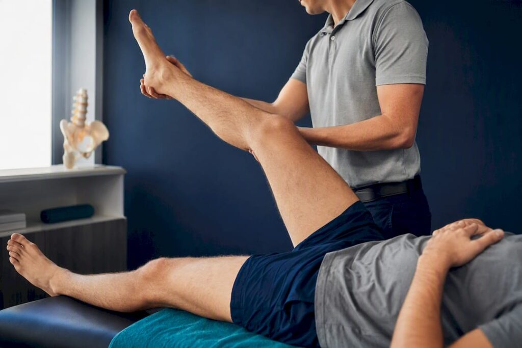 Clinician performing a straight leg raise assessment