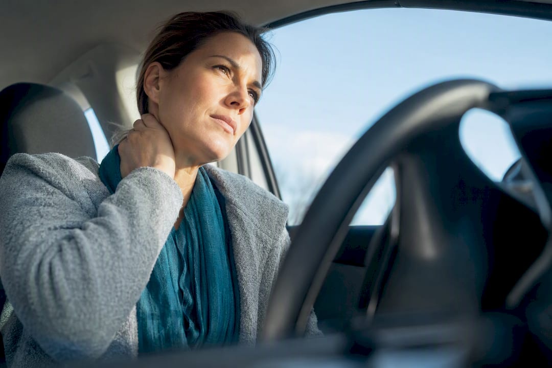 Adult supporting sore neck after whiplash
